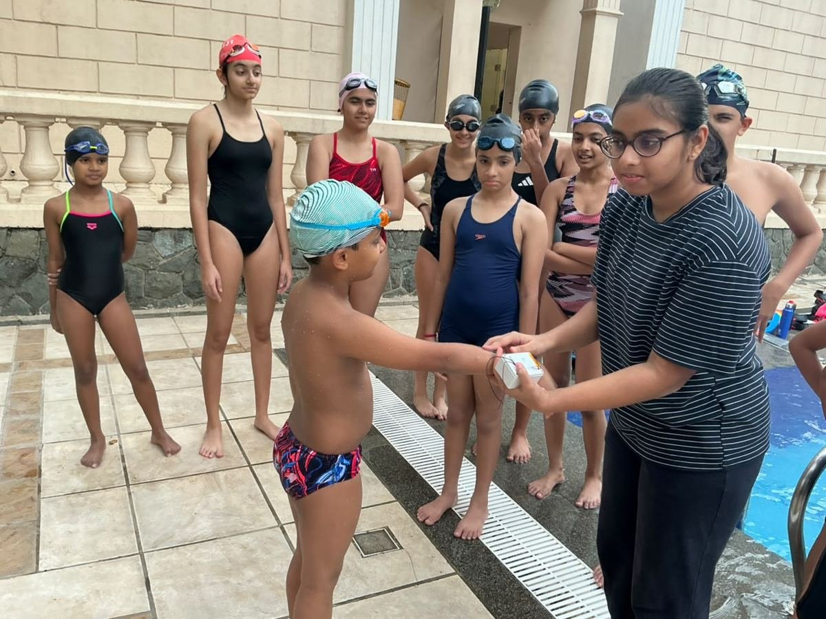 Handing the finished device to a swimmer for testing